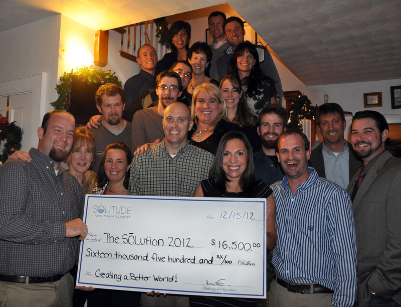 SOLitude Lake Management staff gathers with a check representing the $16,500 donation in cash and goods donated through The SOLution program in 2012. From top to bottom (l-r) are Brad Harris, Trina Duncan, Matthew Phillips, David Beasley, Ellen Stace, Shannon Junior, David Riedl, Gavin Ferris, Lisa Richards, Greg Blackham, Kim Niesel, Brent Weber, Kevin Tucker, Kyle Finerfrock, Cyd Kroskey, Jessica Mueller, Dave Ellison, Tracy King, Dustin Kennedy and John Phelps. SOURCE SUBMITTED